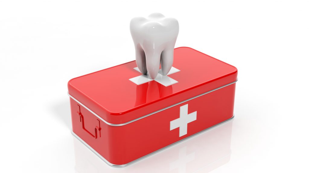 a tooth on top of a red medical kit